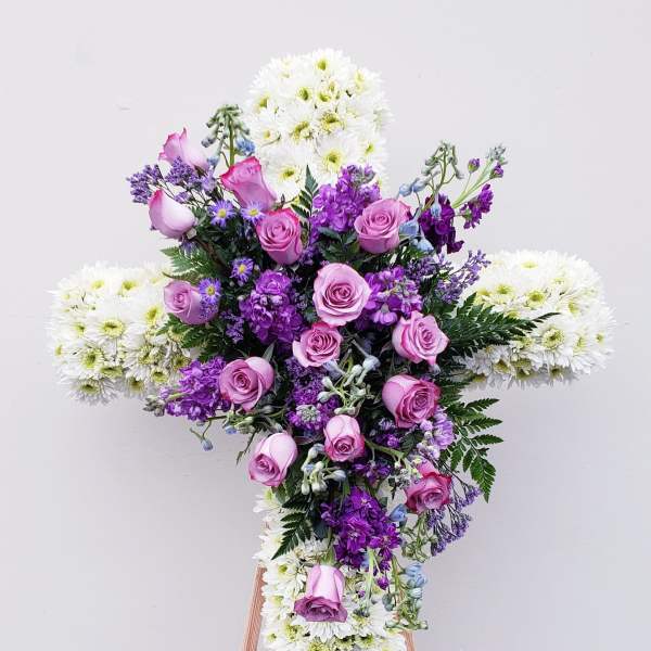 Cross-shaped floral spray with pink roses and white chrysanthemums
