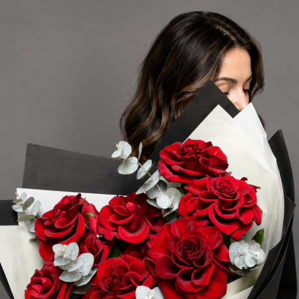 Bouquet of red roses wrapped in black and white paper