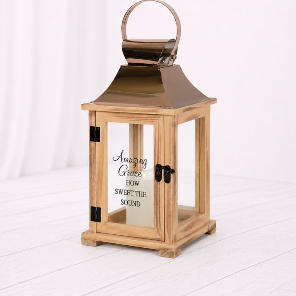 Wooden lantern with a metal top and glass panels