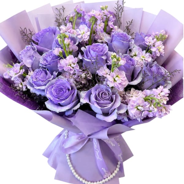 Lavender rose bouquet with small lilac flowers wrapped in purple paper