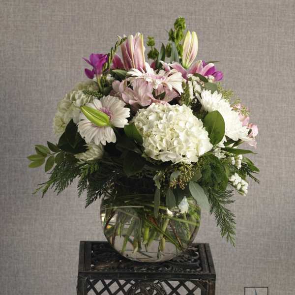 Mixed pink and white flower arrangement in a glass vase