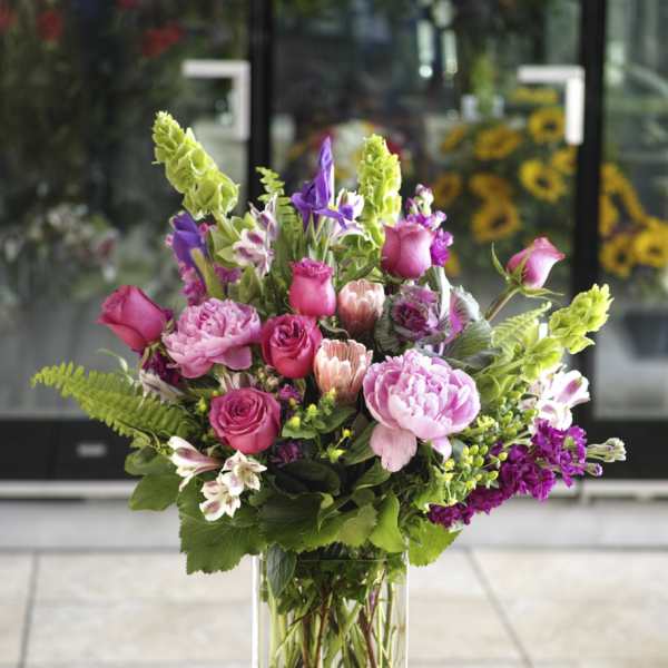 Pink and purple mixed bouquet in a clear glass vase
