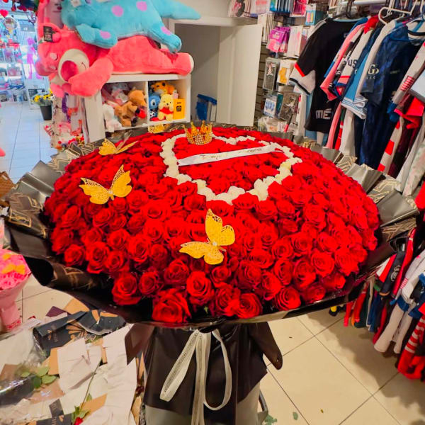 Large bouquet of red roses with butterfly decorations in a shop