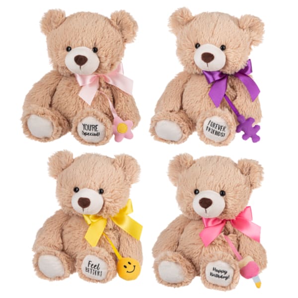Four plush teddy bears with ribbons and small hanging charms.