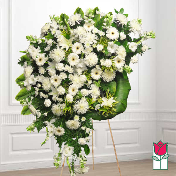 Large white funeral spray on a standing easel