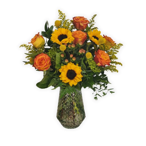 Bouquet of orange roses and yellow sunflowers in a textured glass vase