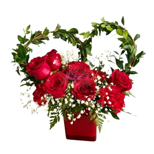 Red roses in a red vase with a leafy heart-shaped frame