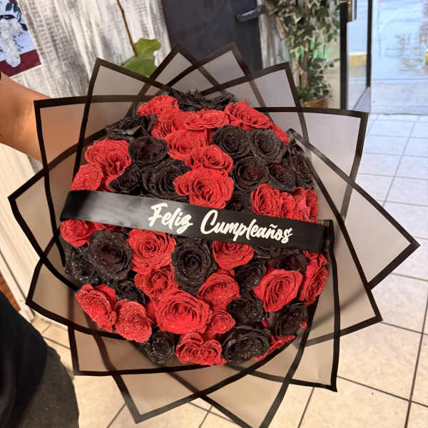 Bouquet of red and black roses with a birthday ribbon