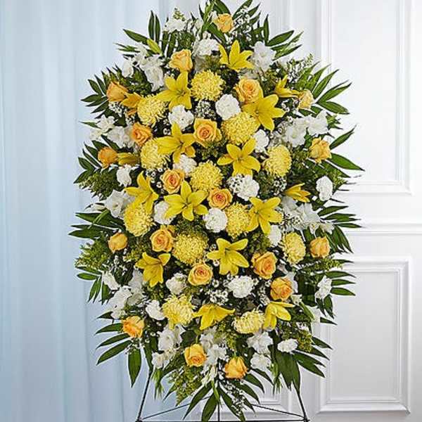 Large standing floral spray with yellow and white flowers on an easel