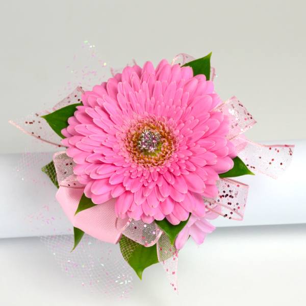 Pink gerbera daisy corsage with glitter and pink ribbons