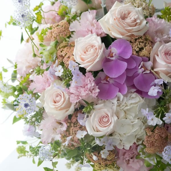 Bouquet of pale pink roses, purple orchids, and white hydrangea