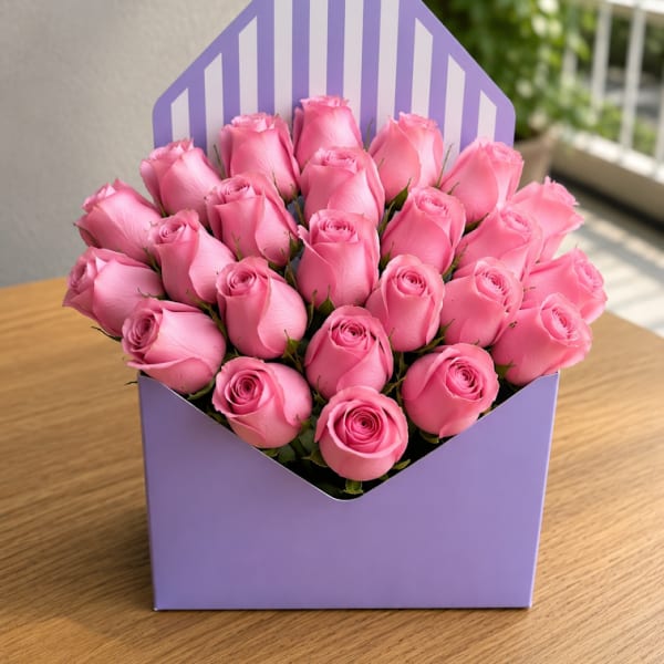 Pink roses arranged in a lavender gift box