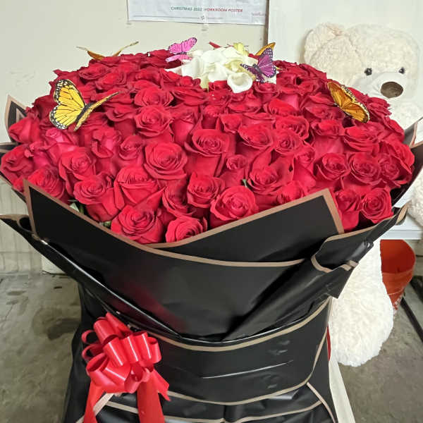 Large bouquet of red roses with white roses and butterfly accents