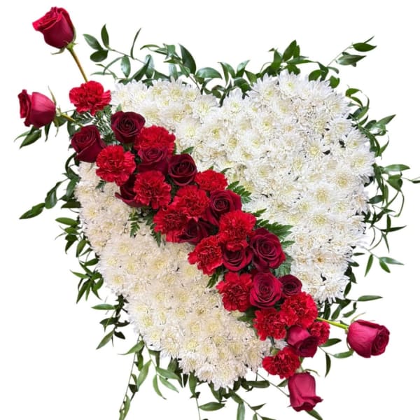 Heart-shaped floral arrangement with red roses, red carnations, and white chrysanthemums