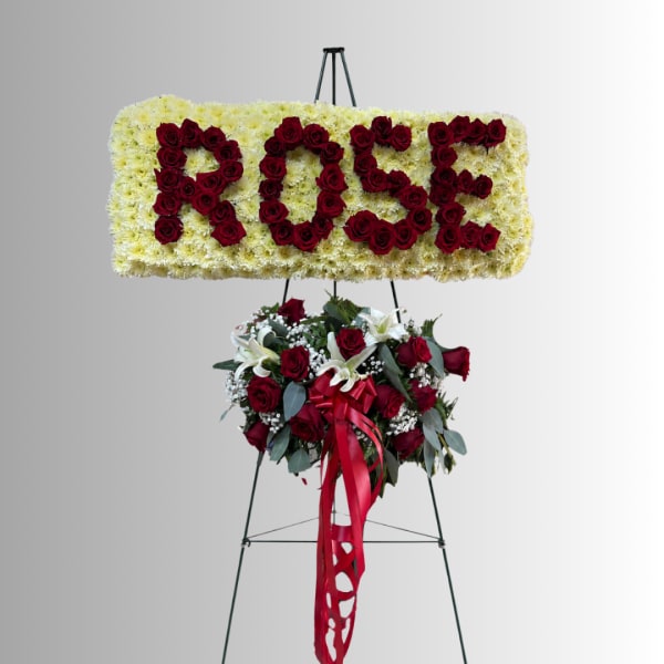 Floral standing display spelling ROSE above a red rose bouquet.