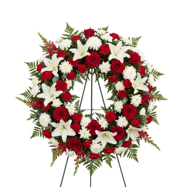 Red and white floral wreath on a stand