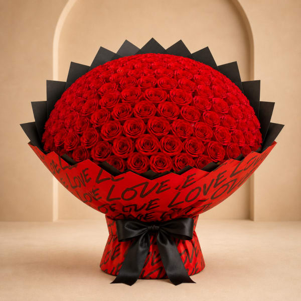 Large bouquet of red roses wrapped in red paper with black ribbon
