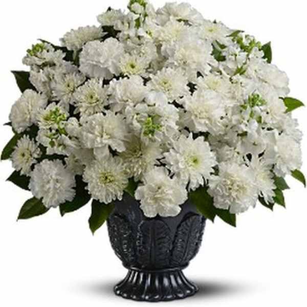 White chrysanthemum bouquet in a dark urn vase