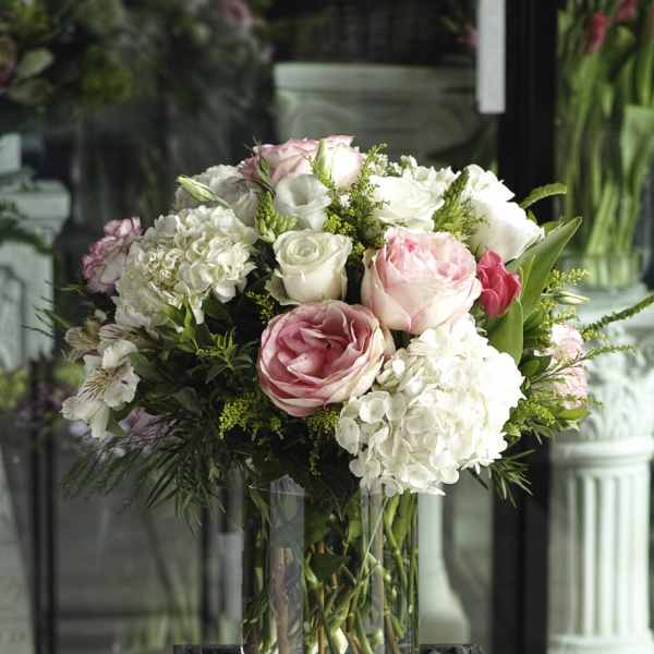 Pink and white rose bouquet in a clear glass vase