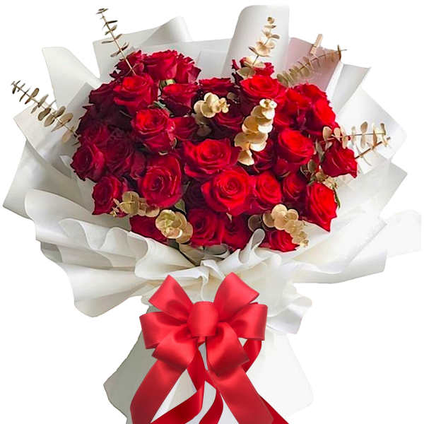 Bouquet of red roses wrapped in white paper with a red ribbon