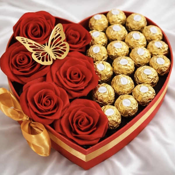 Heart-shaped box with red roses and gold-wrapped chocolates