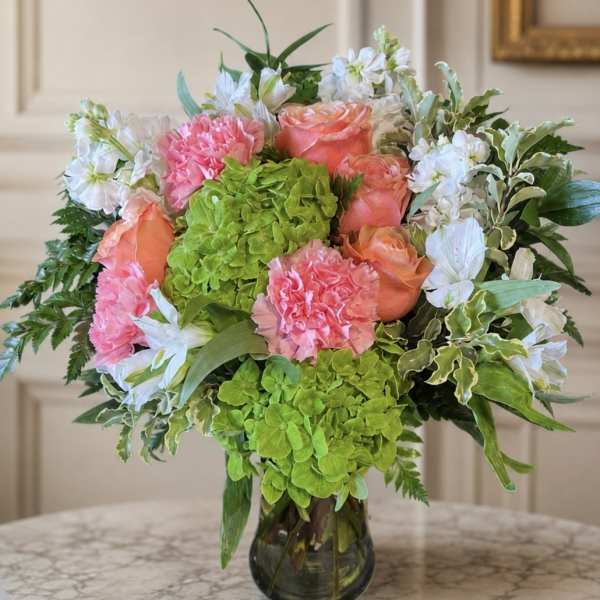 Bouquet of pink and peach flowers in a glass vase