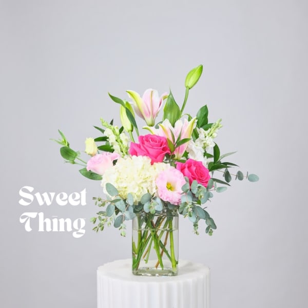 Pink and white bouquet in a clear glass vase