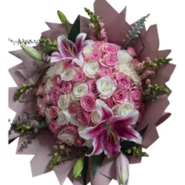 Pink and white rose bouquet with lilies wrapped in mauve paper