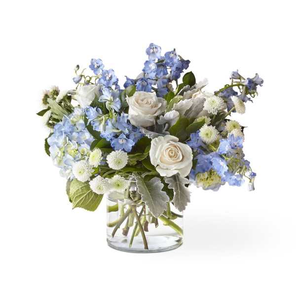 Blue and white flower arrangement in a clear glass vase
