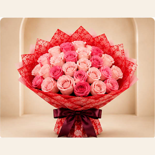 Bouquet of pink roses wrapped in red paper with a dark ribbon