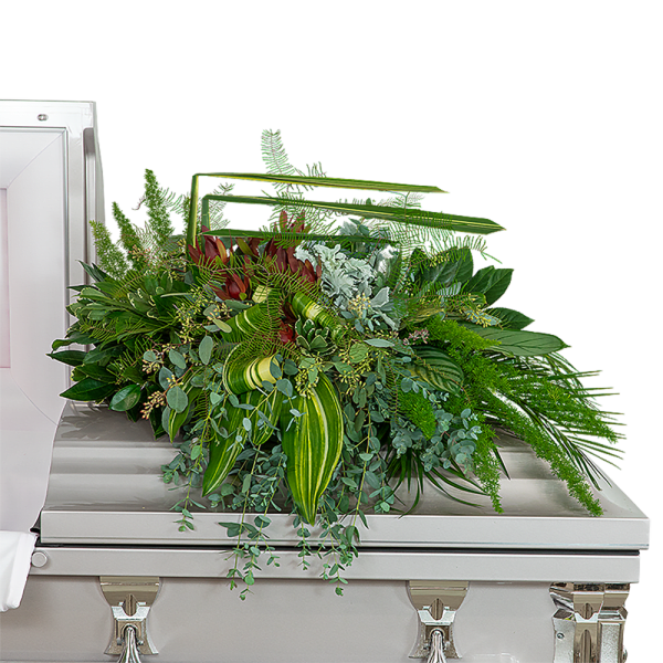 Large green floral spray on a silver casket
