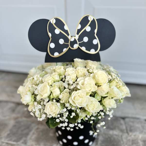 White rose bouquet in a black polka-dot vase with a Minnie Mouse topper
