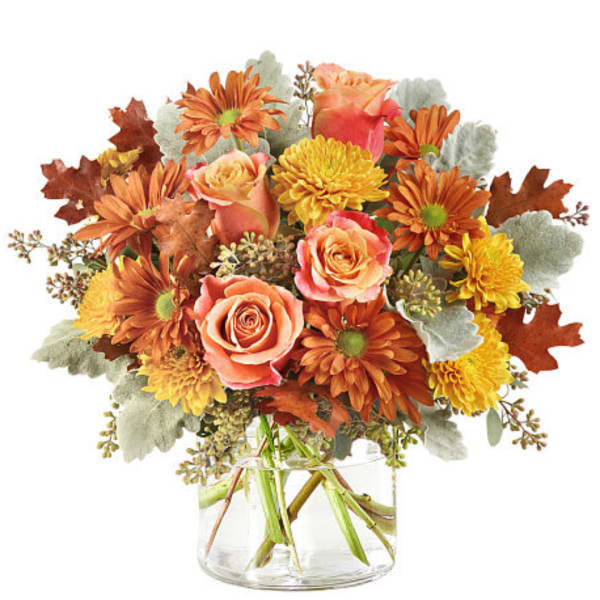 Bouquet of orange and yellow flowers in a clear glass vase