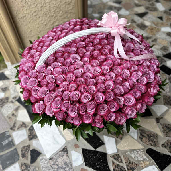 Large basket of pink roses with a ribbon bow