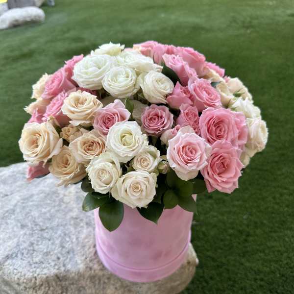 Pink and white rose bouquet in a pink container