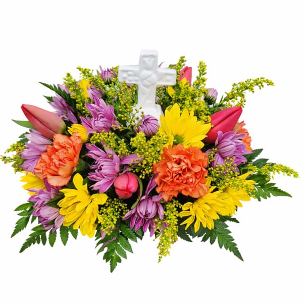 Colorful floral arrangement with a white cross centerpiece
