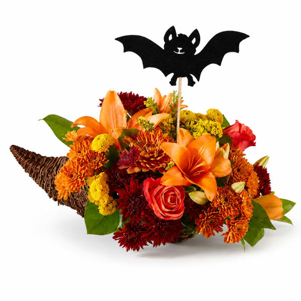 Halloween bouquet in a wicker horn with a bat topper