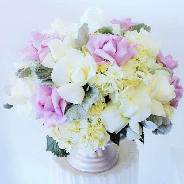 Pink and white rose bouquet in a pale vase