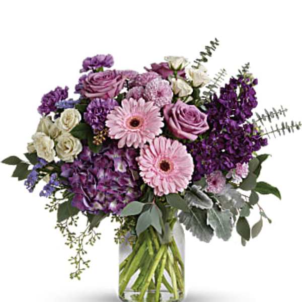 Purple and pink mixed bouquet in a clear glass vase