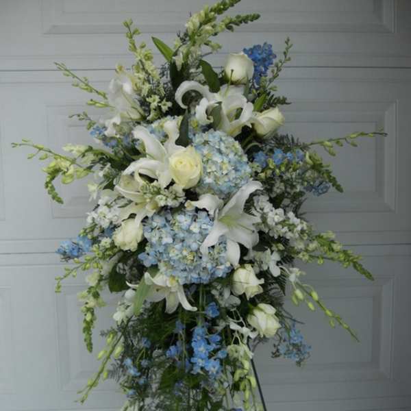 Tall standing floral spray with white lilies and blue hydrangeas