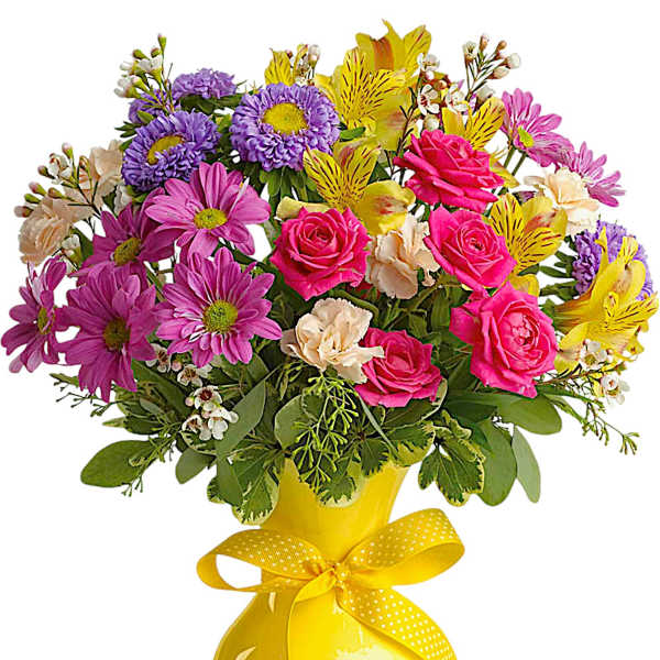 Colorful mixed bouquet in a yellow vase with a ribbon bow
