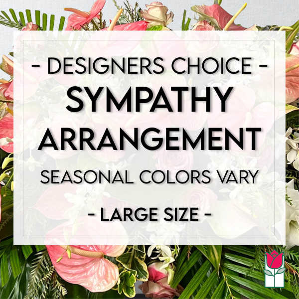 Large sympathy arrangement with pink flowers and tropical foliage