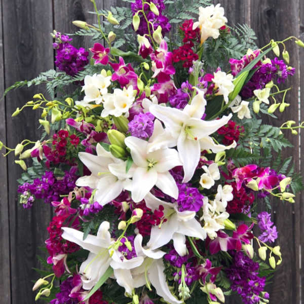 Standing floral spray with white lilies and purple orchids