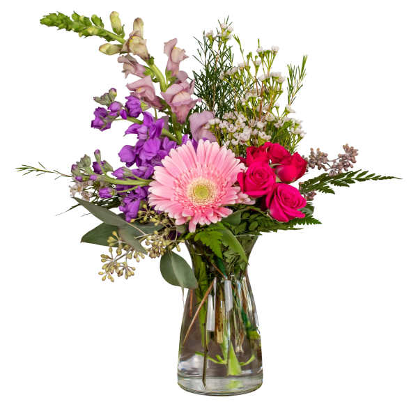 Mixed bouquet with pink gerbera, roses, and purple snapdragons in a glass vase