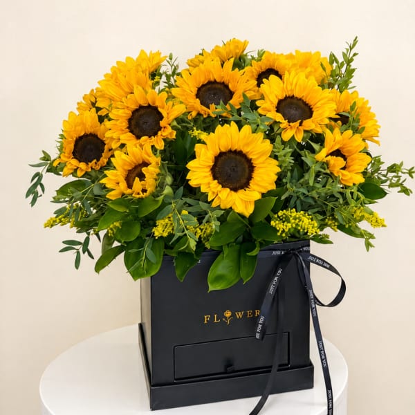 Sunflower arrangement in a black gift box with a ribbon