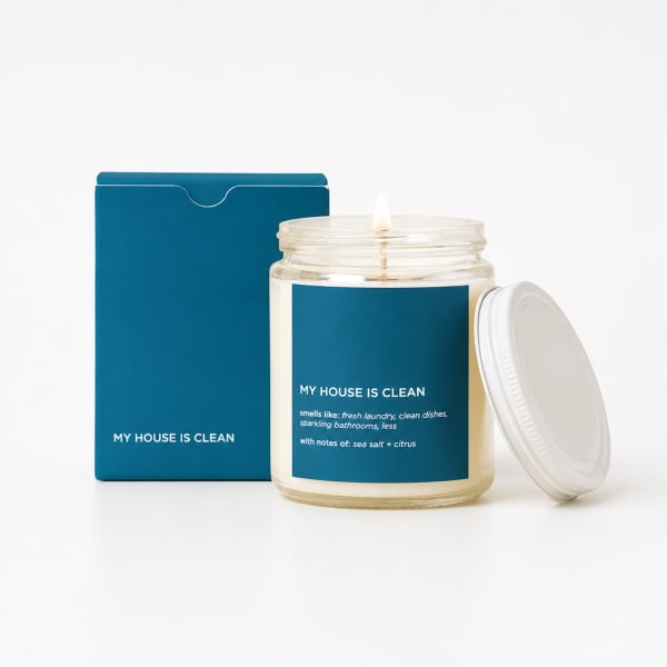 Scented candle in a glass jar with a blue box and white lid