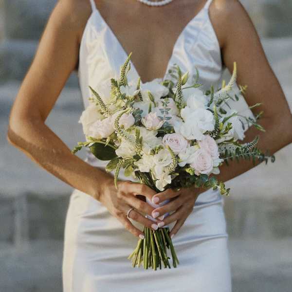 Bride holding a white and blush wedding bouquet