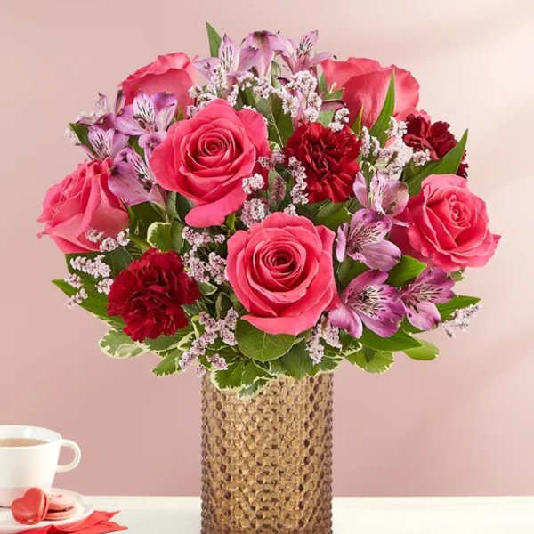 Pink and red rose bouquet in a textured gold vase