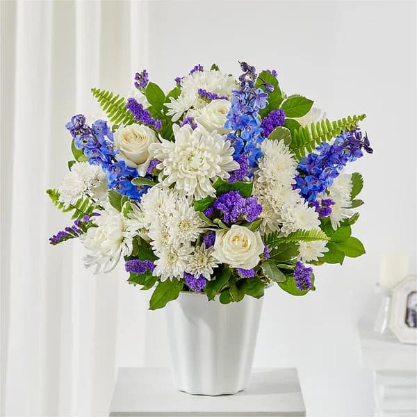 White and purple mixed bouquet in a white vase
