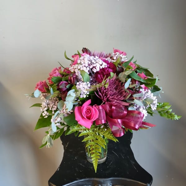 Pink and purple mixed bouquet in a clear glass vase